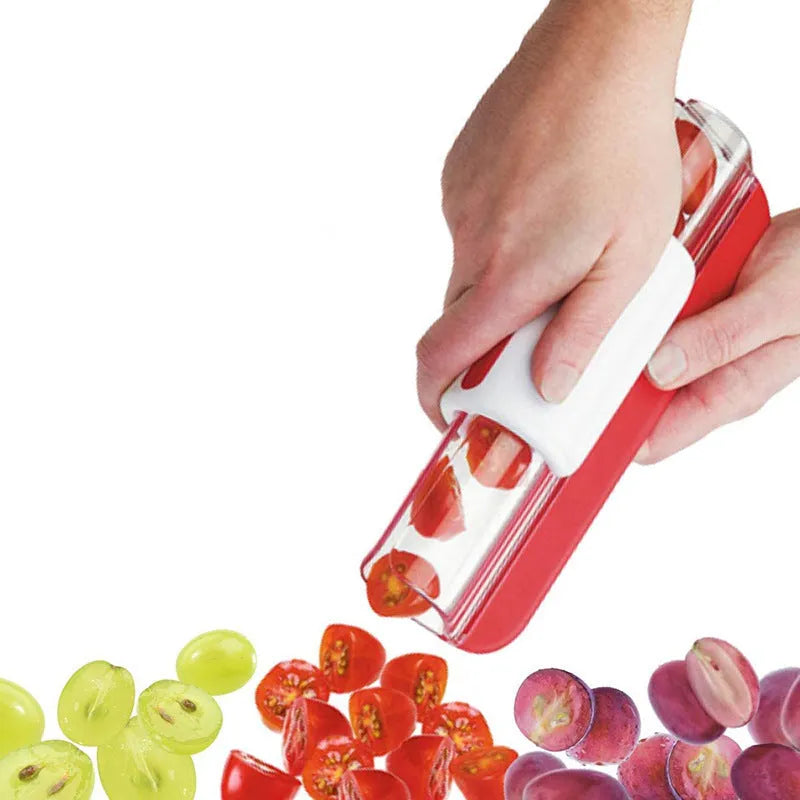 Handheld tomato and grape slicer in green with concealed stainless steel blade on a white background