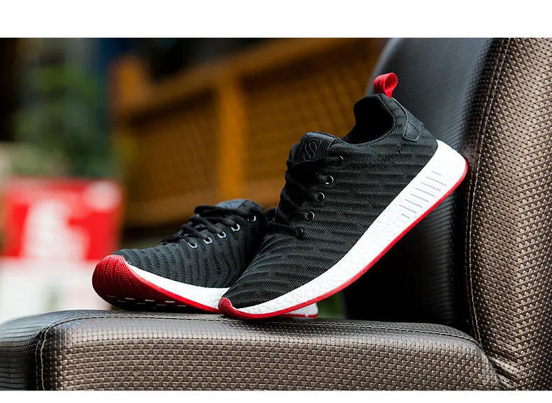 Men Malcolm Sneaker in black from side view showing mesh fabric upper and low-top design