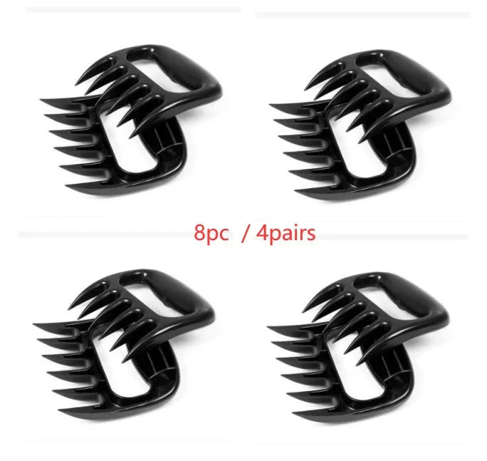 Two black bear claw meat shredder forks with patterned handles for barbecue use.