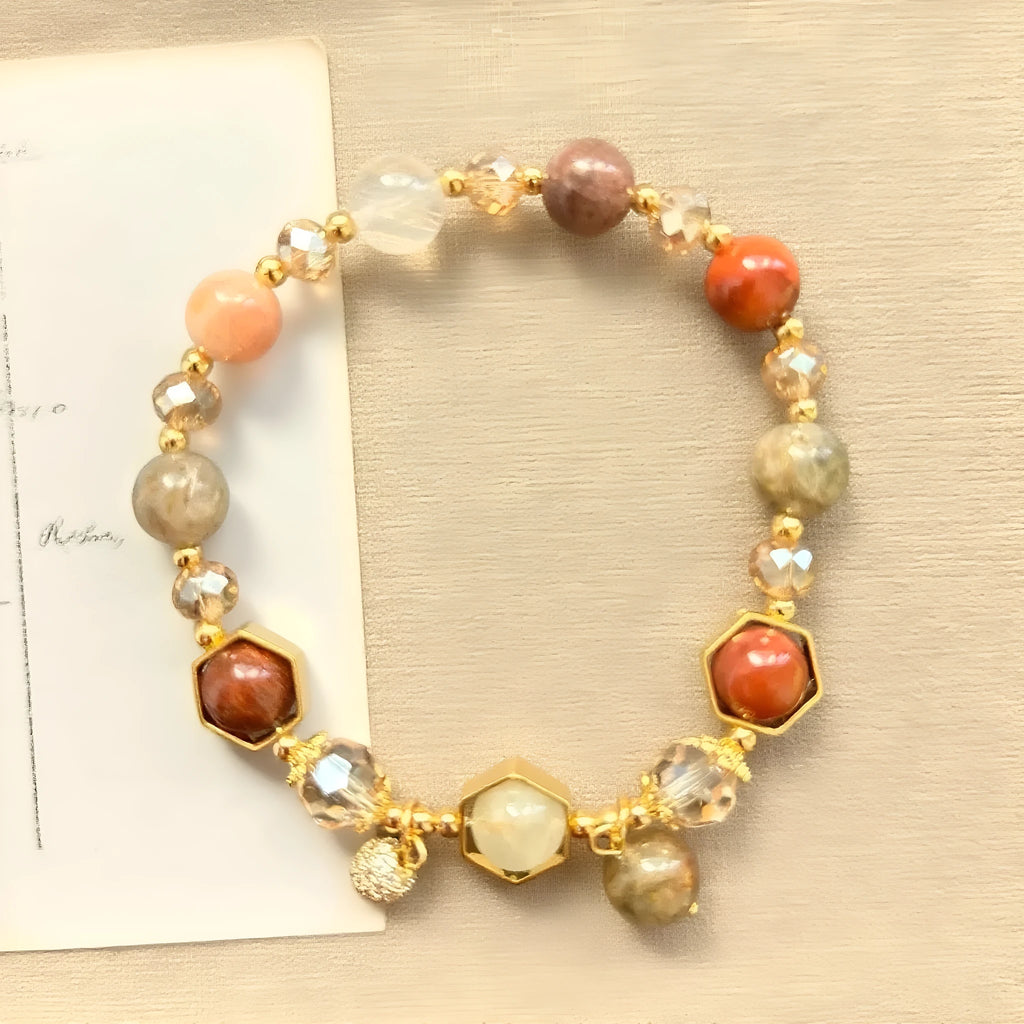 Gold-coloured citrine bracelet with hand-woven construction showing auspicious Chinese symbols
