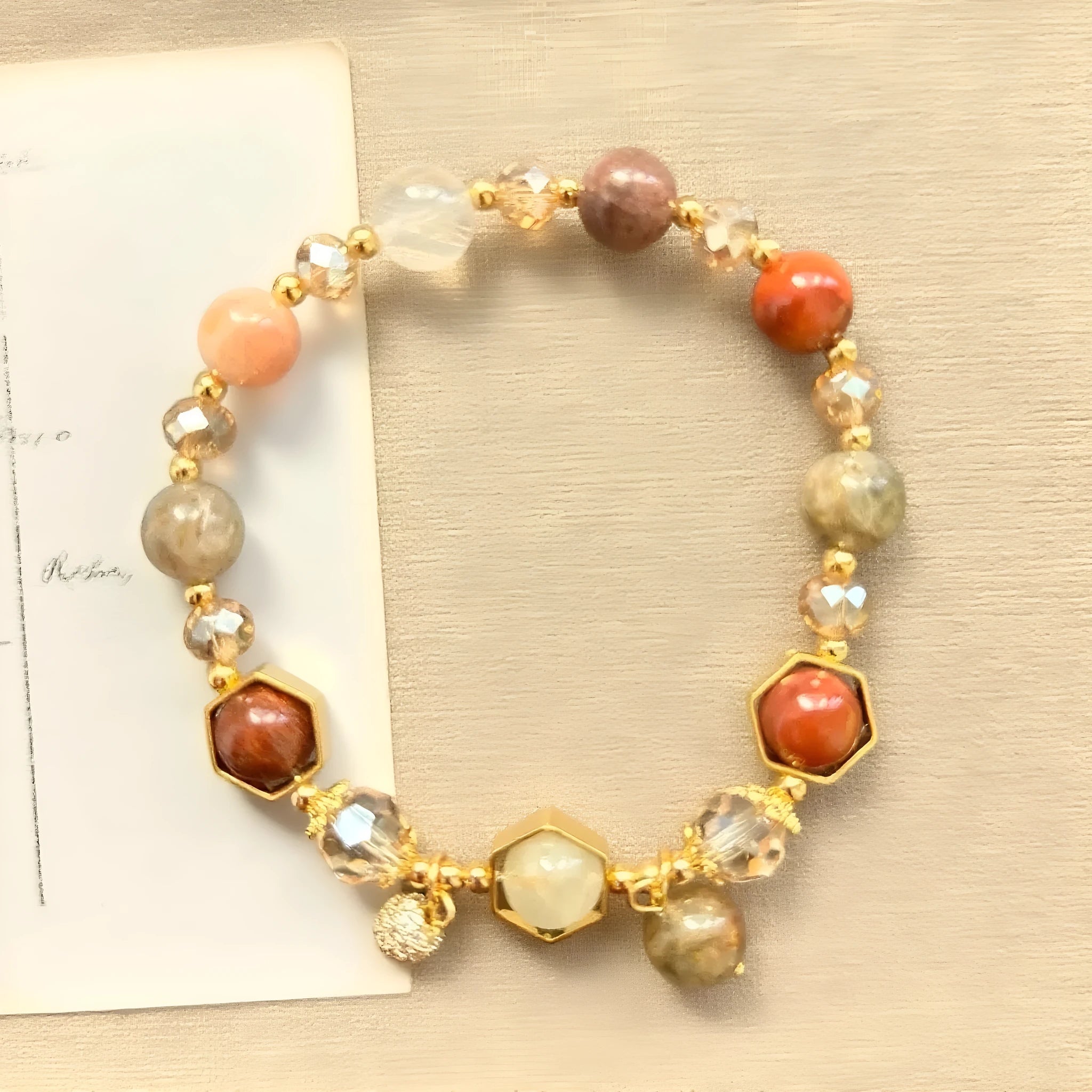 Gold-coloured citrine bracelet with hand-woven construction showing auspicious Chinese symbols