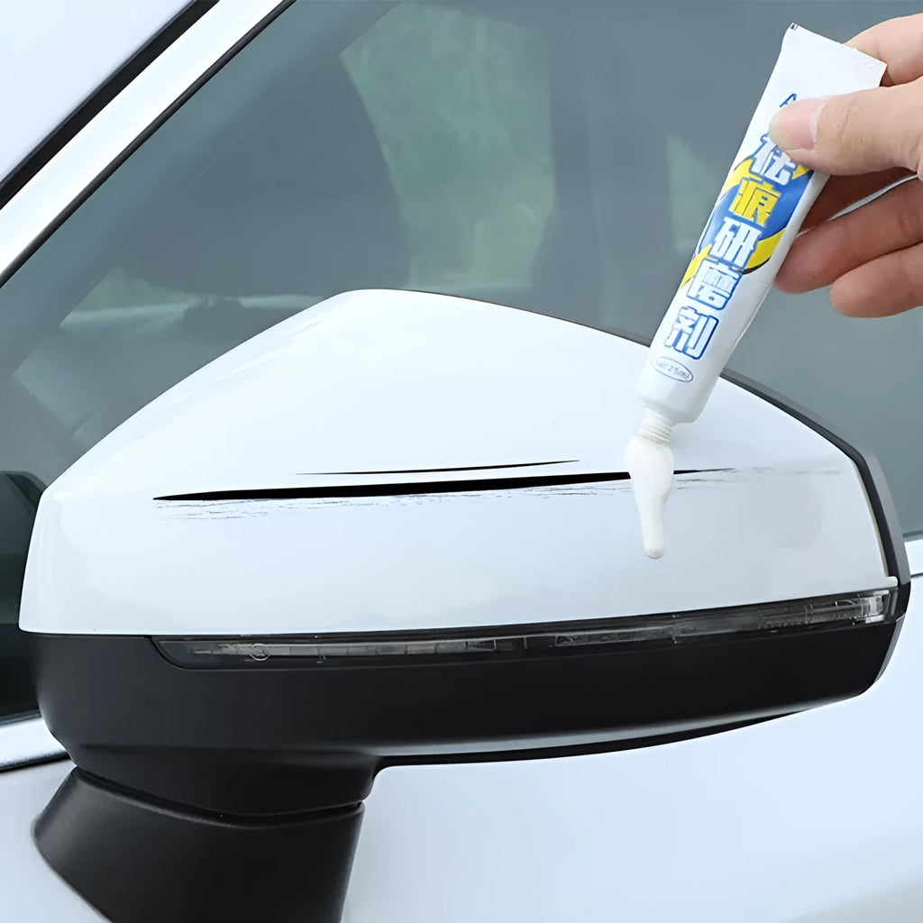 Automotive paint repair pen touch-up kit with paint pen, wax, sponge, and sandpaper for car scratches.