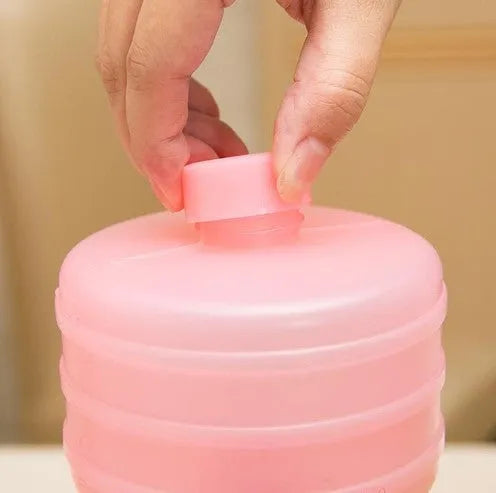 Pair of water-filled fitness dumbbells in pink and green, polypropylene, approximately 1kg each when filled