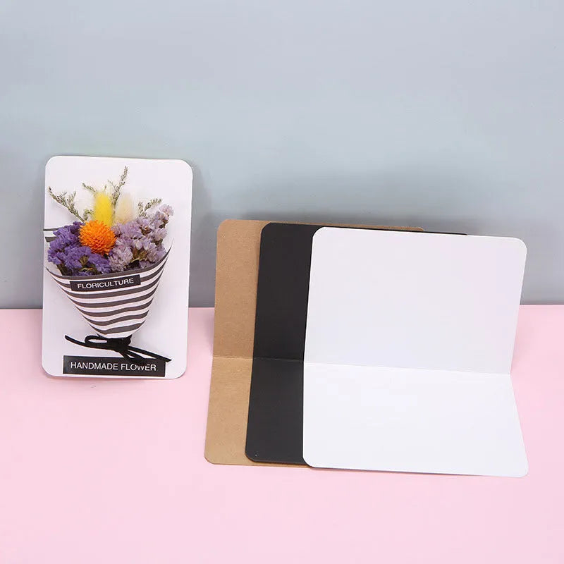 Pack of 100 blank folded kraft paper cards in 10x15 cm size, shown in black, brown, and white colours.