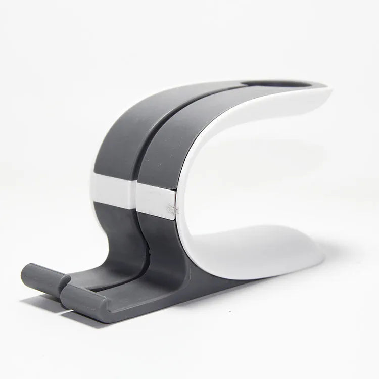 Grey and green Apple iPhone and Apple Watch charging stand on desktop