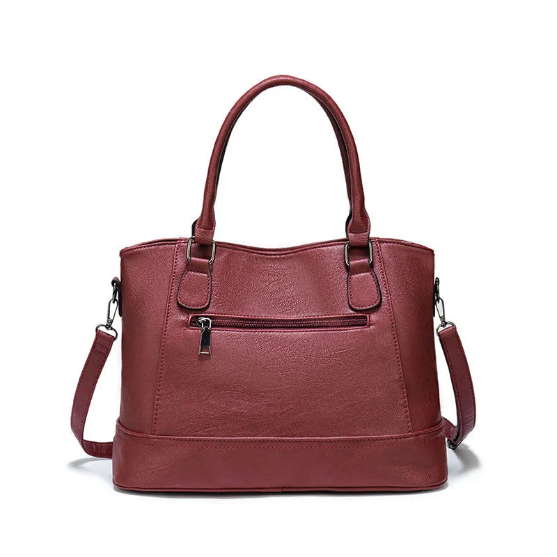 Women's PU leather handbag in black, horizontal square shape, with crossbody strap and sewing line detail