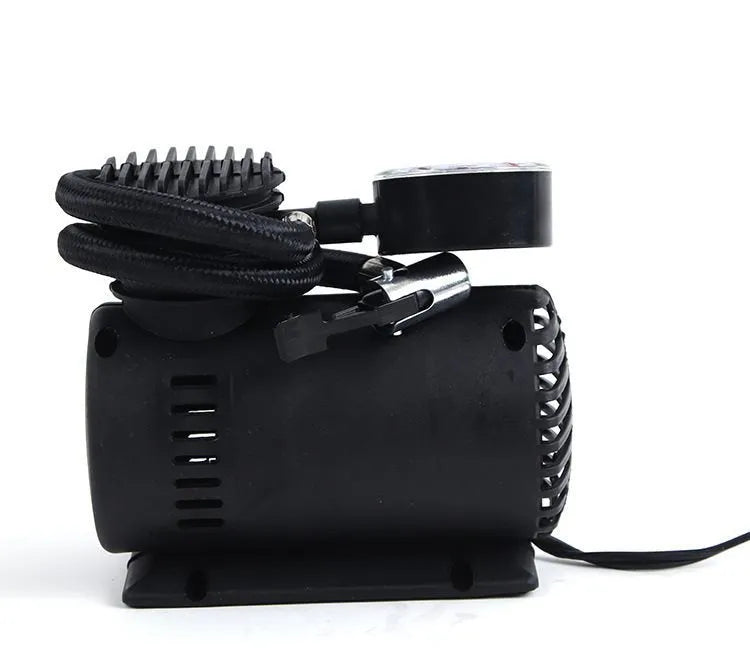 Black portable 12V mini car air compressor with pressure gauge, hose, and two nozzle adapters on grey background