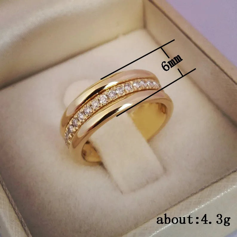 Gold-plated copper geometric ring with inlaid zircon on white background
