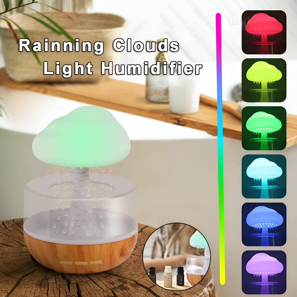 White cloud-shaped humidifier with LED night light and water droplet effect on a table.