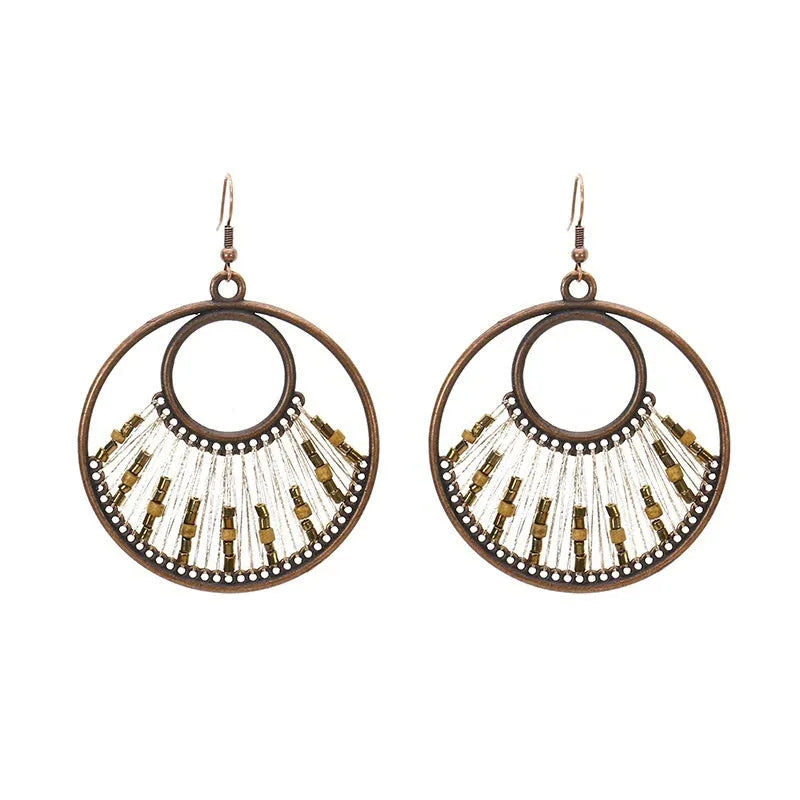 Bohemian hand-woven gold thread alloy earrings with geometric quadrilateral shape on a white background