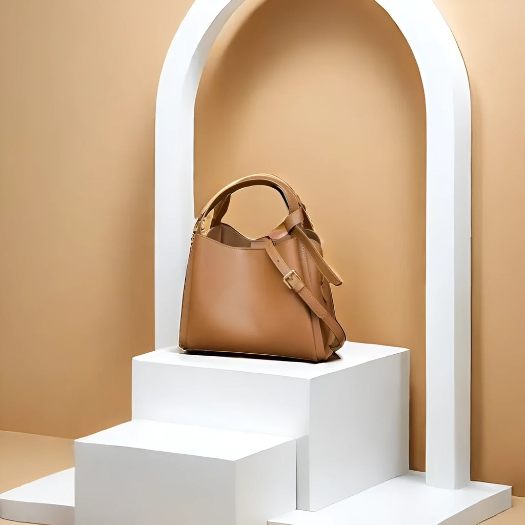 Genuine cowhide leather women's crossbody shoulder bag in bucket shape with interior zipper pockets.