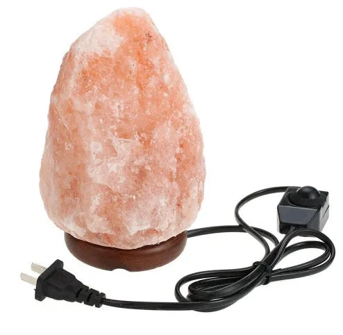 Rose crystal salt lamp with natural rock salt shade on a bedside table, warm glow, compact size.