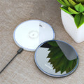 Black wireless charging pad with LED indicator for phones and headphones
