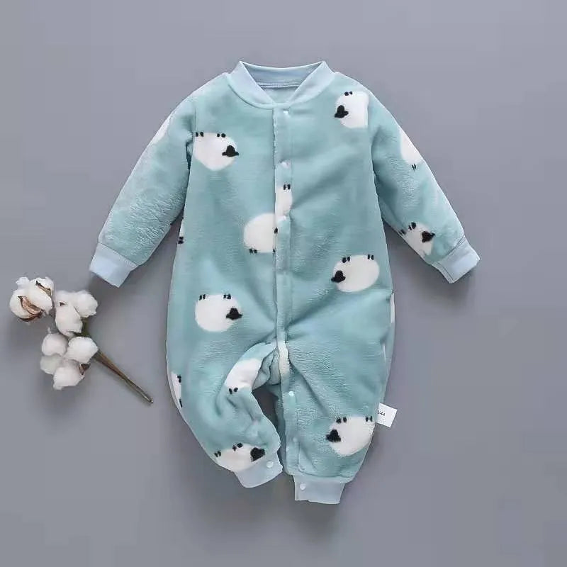 A baby wearing a long sleeve cotton flannel romper in a pink pineapple print pattern.
