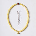 Yellow jade coloured topaz bracelet with double ring design and lotus seedpod beads
