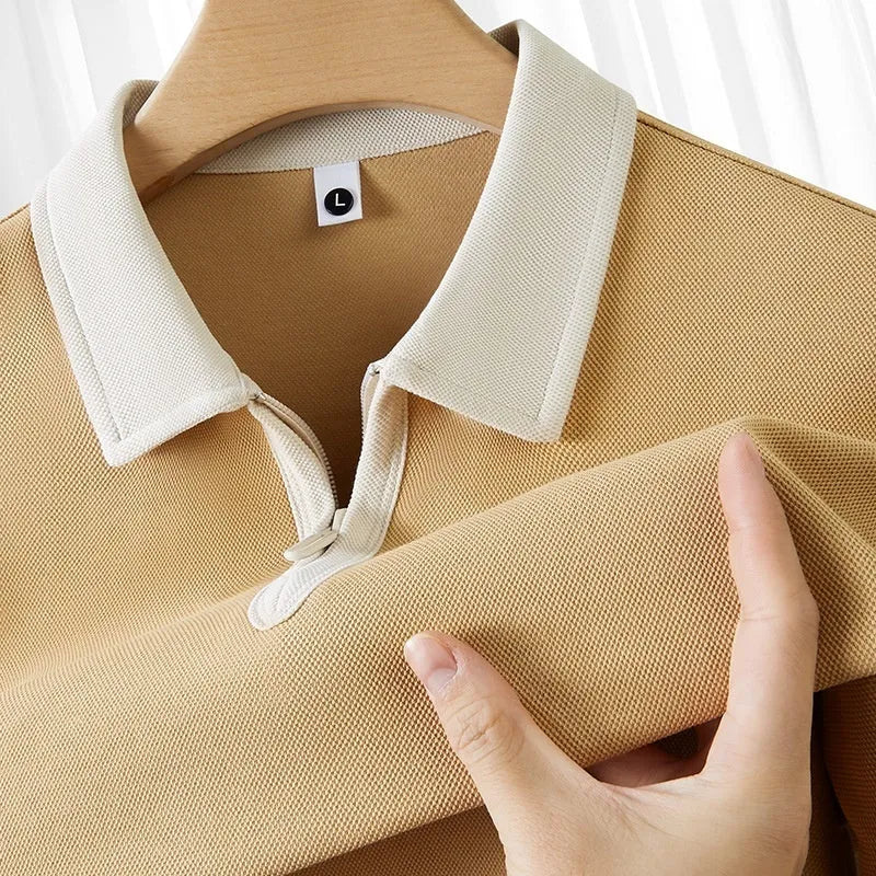 Man wearing a solid colour zipper and lapel polo shirt with short sleeves in a loose fit.
