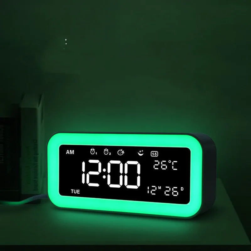 Blue rectangular multifunctional LED atmosphere light alarm clock with digital display on a wooden surface.