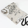 Black Peony floral print canvas pencil roll bag unrolled showing 24 or 72 holes for pencils.
