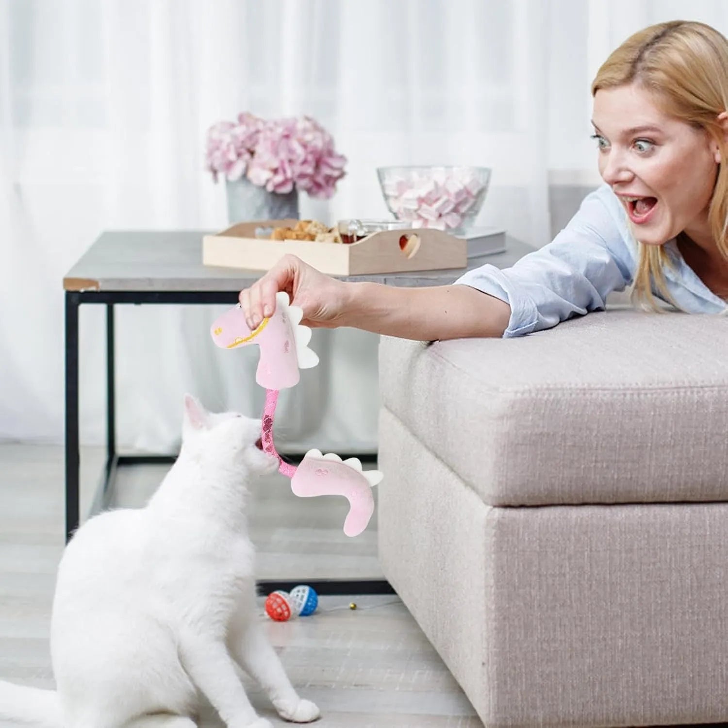 Set of four cat toys including plush, rope, and spring toys in pink, purple, and yellow colours