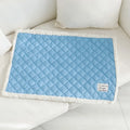 Quilted terry cloth cat blanket in blue, shown alongside pink, yellow, and grey colour options.