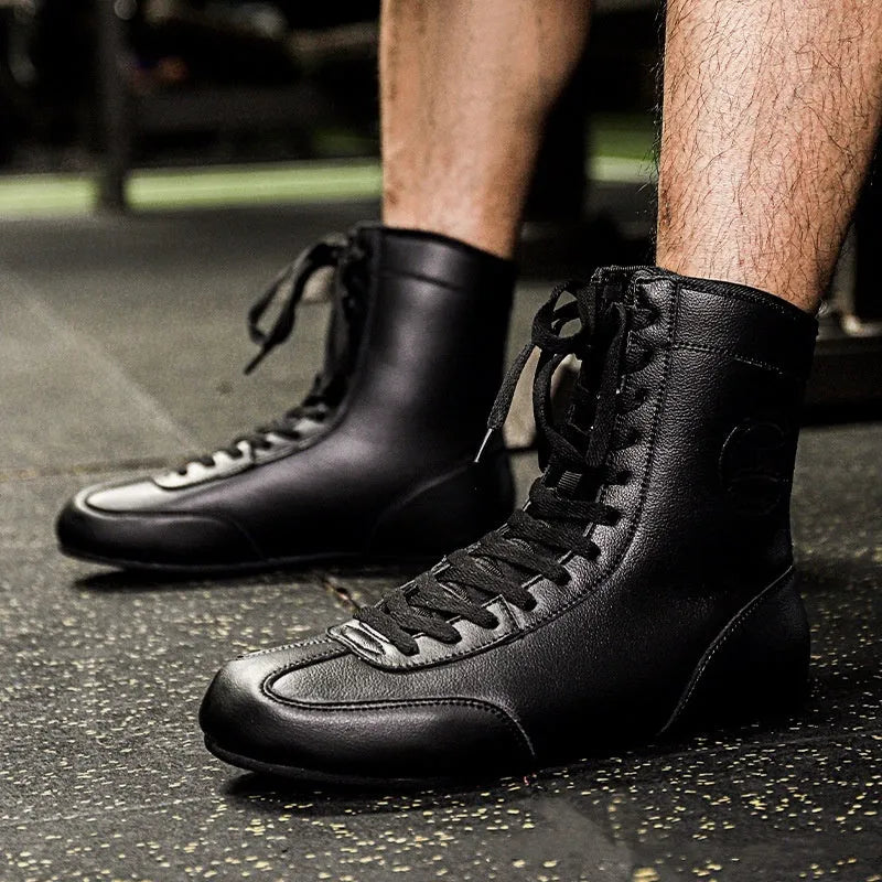 Professional black gold mesh boxing shoes with white leather panels and black detailing, shown in size 42.