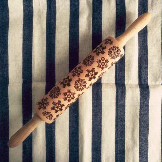 Personalized Christmas rolling pin with a variety of embossed holiday designs, including snowflakes, reindeer, and Merry Christmas patterns