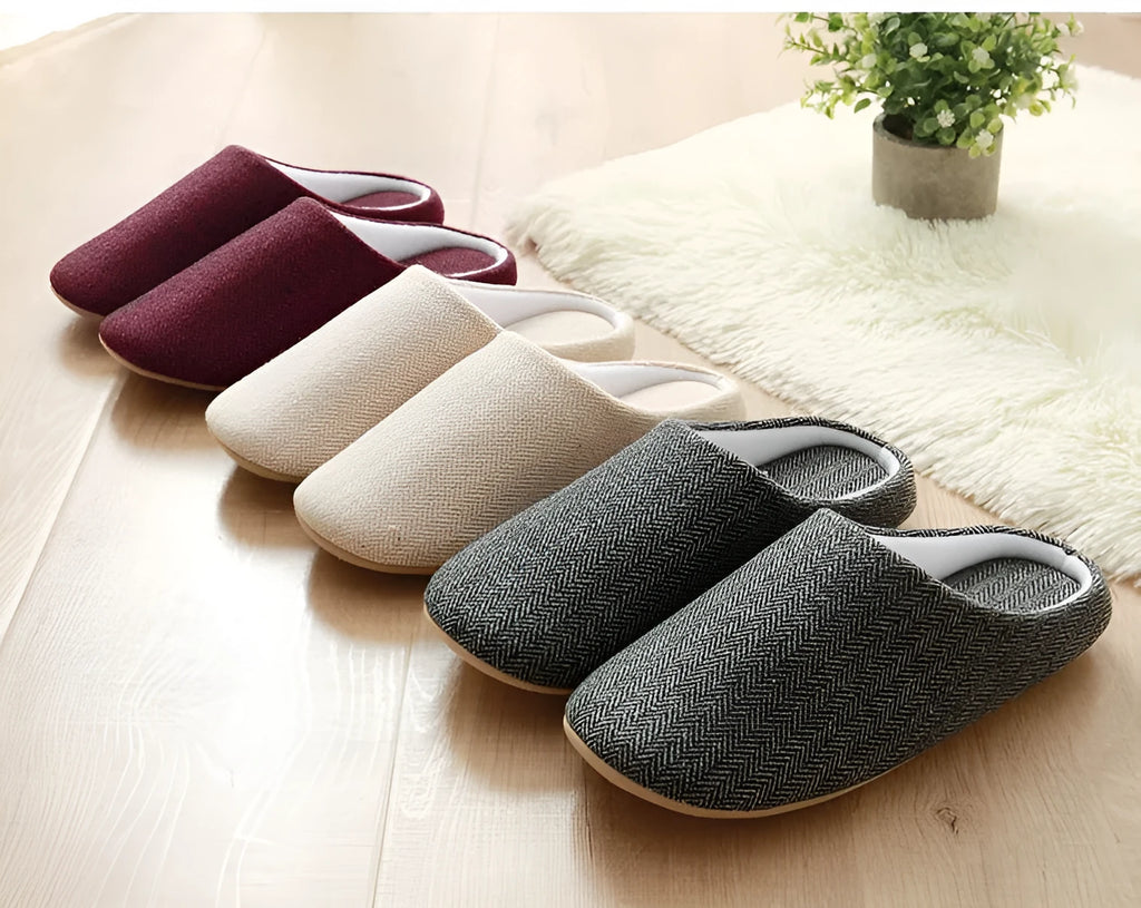 Men's cotton black indoor slippers with anti-skid sole on a home floor
