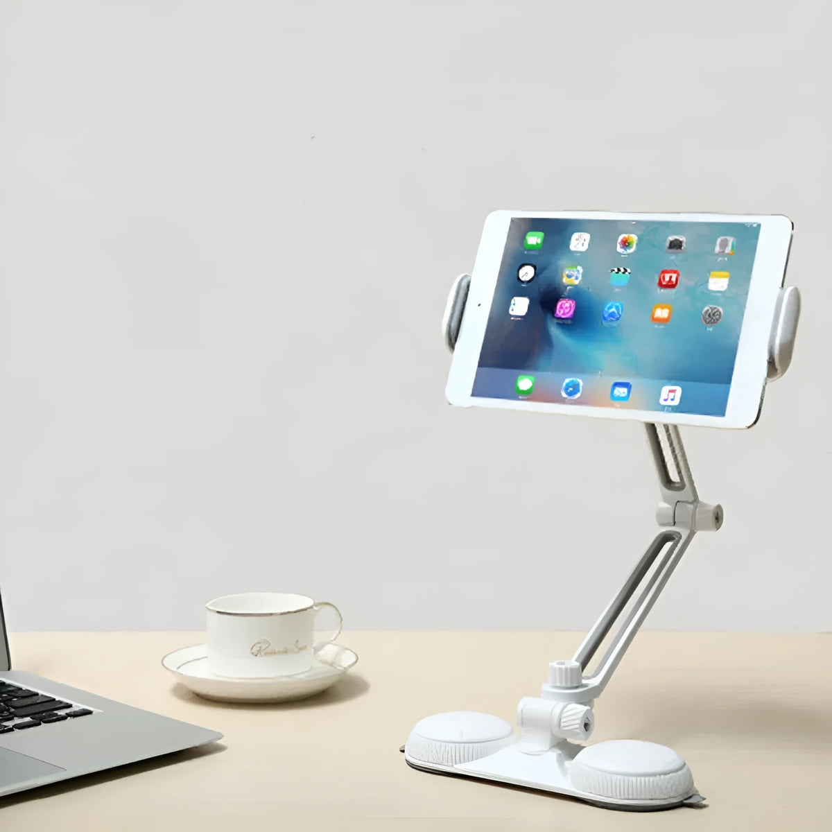 Aluminium alloy sucker bracket with double suction cup holding a mobile phone on a smooth table surface