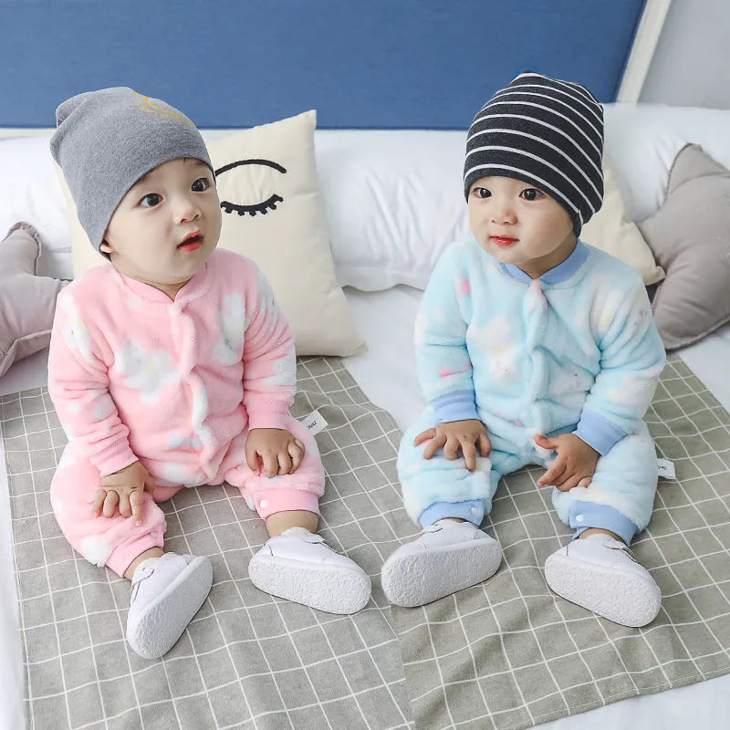 A baby wearing a long sleeve cotton flannel romper in a pink pineapple print pattern.