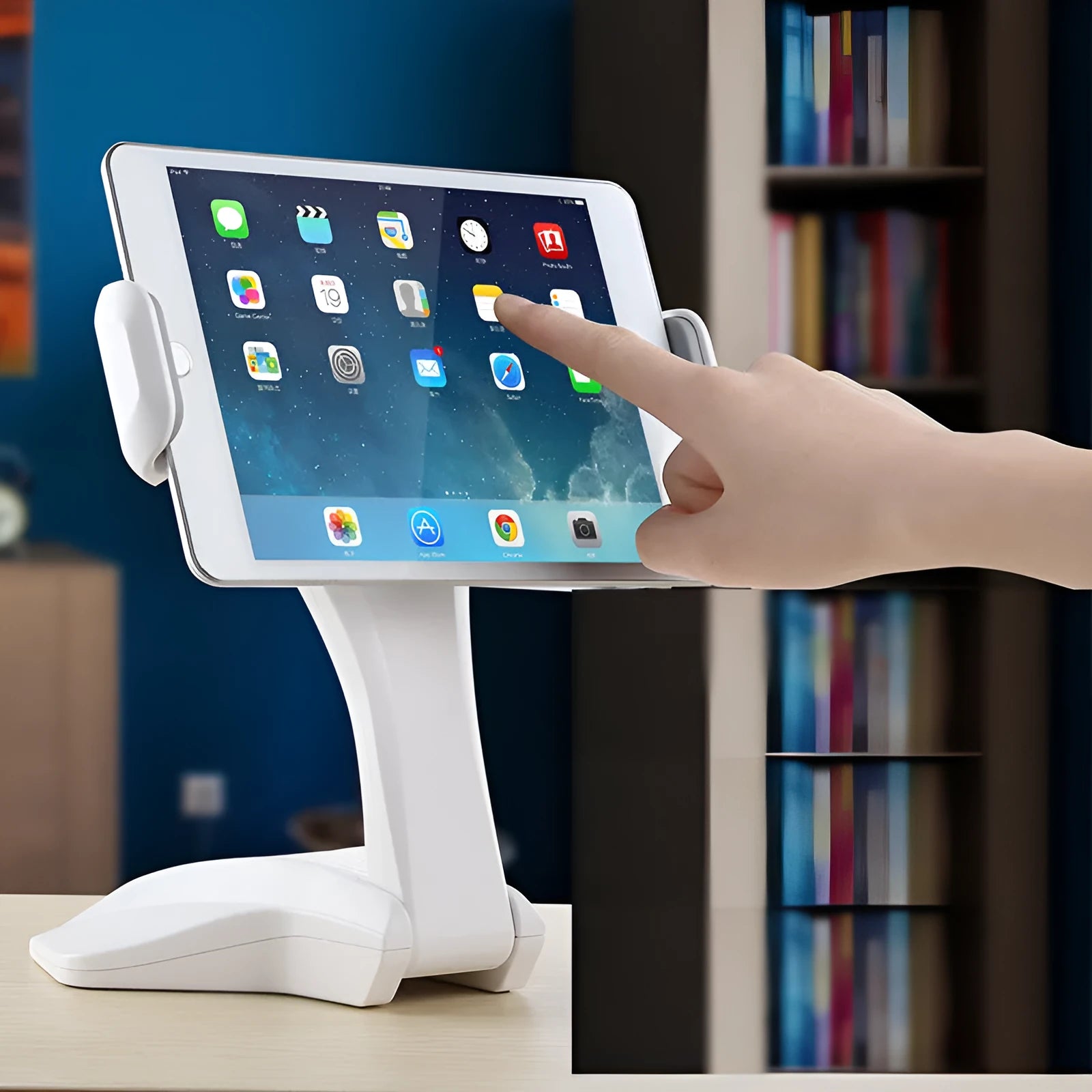 White adjustable tablet support stand with clip extended, holding a tablet on a desk.