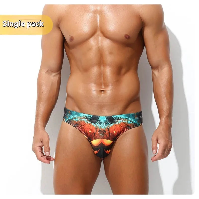 Man wearing grey low waisted digital print polyester shorts, showcasing the briefs fit and graphic design.