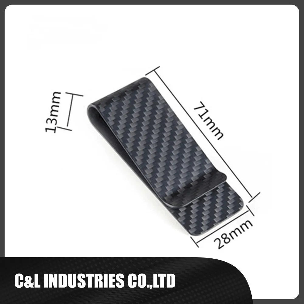 Black glossy striped carbon fibre money clip on a flat surface showing its slim profile and textured pattern