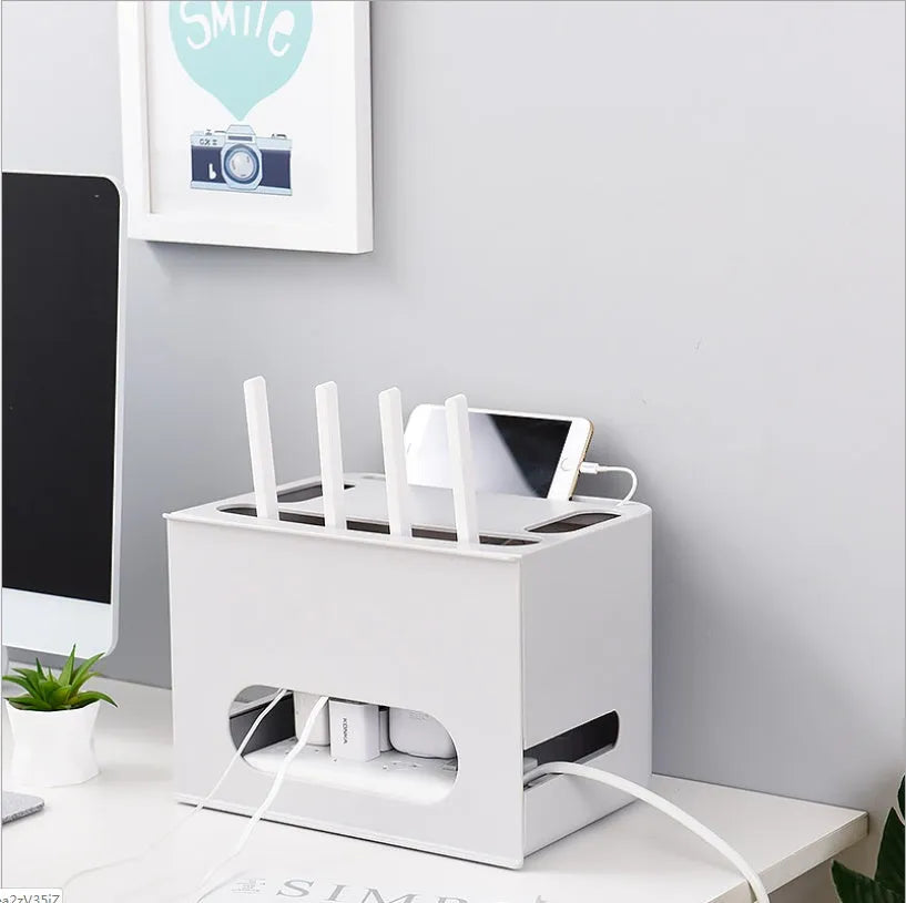 Grey and white plastic router storage box with cable ports for home cable management