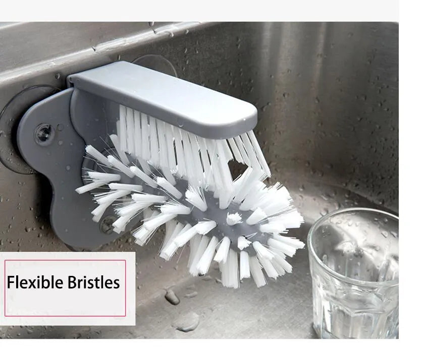 Grey rotating cup brush with two suction cups for wall mounting, shown cleaning a glass