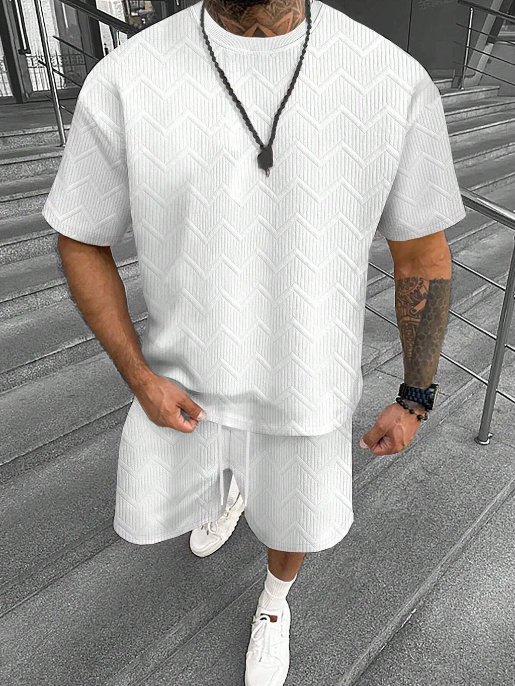 Men's short sleeve top and shorts suit with printed pattern for sports leisure wear.