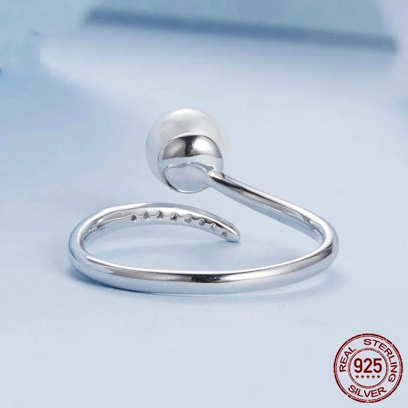 Women's S925 sterling silver adjustable ring with a natural pearl on an open loop.