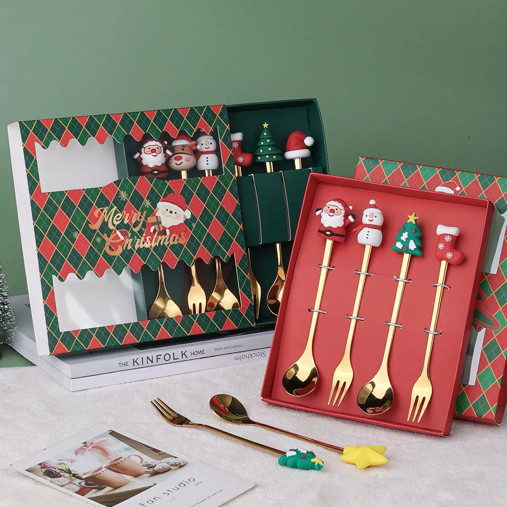 Red stainless steel Christmas spoon and fork set with snowman and Christmas tree designs on the handles.