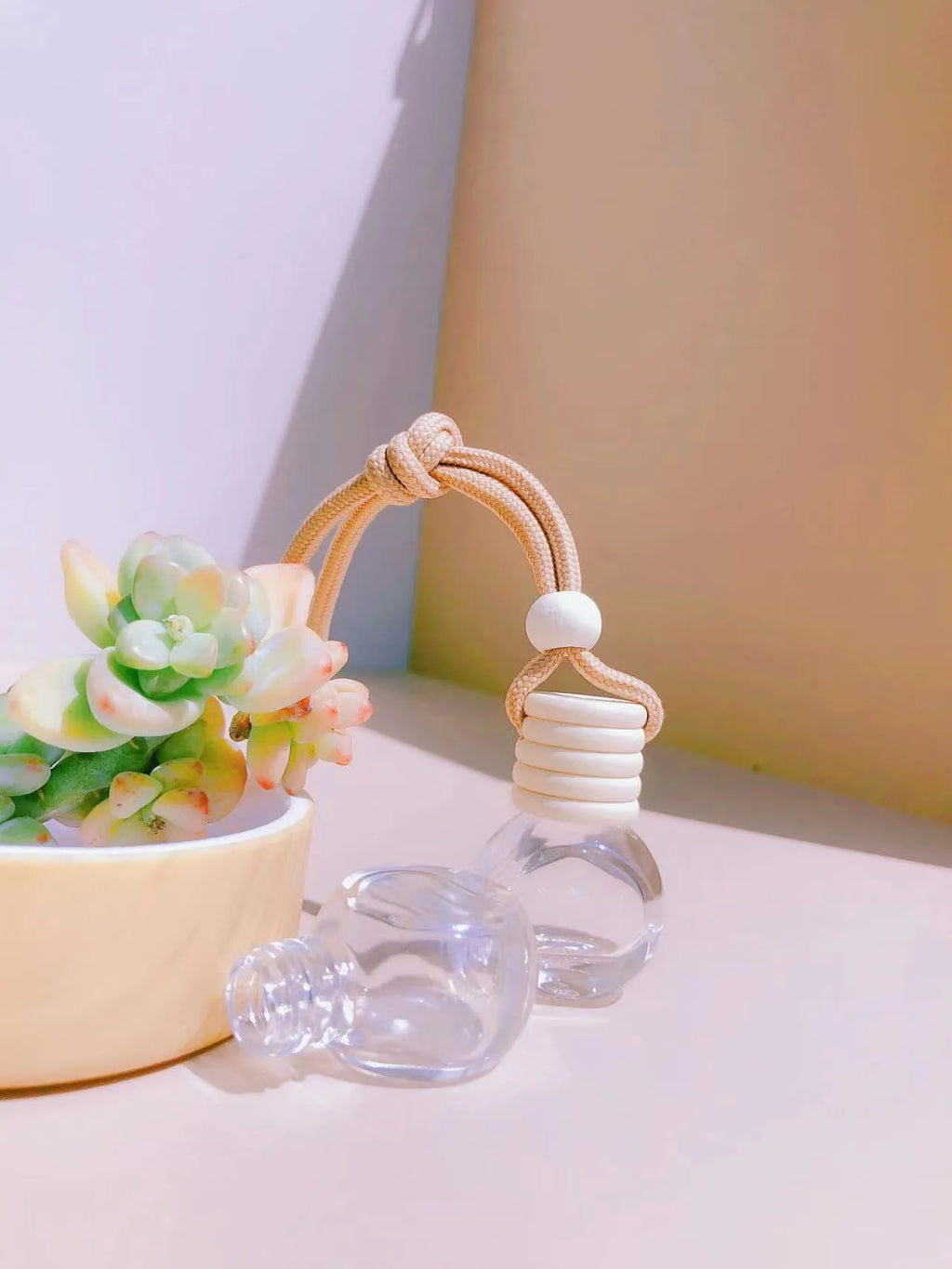 Car perfume pendant in glass bottle showing cylinder, diamond, flat drum and square style options