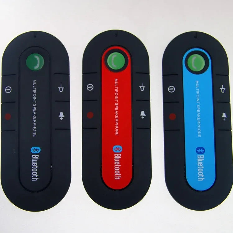 Black vehicle-mounted Bluetooth handsfree unit clipped to a car sun visor, with car charger and cable.