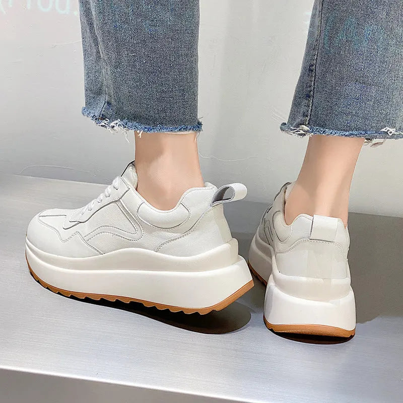 Women's beige cattlehide leather low-top casual sports shoes with cross strap and round toe.
