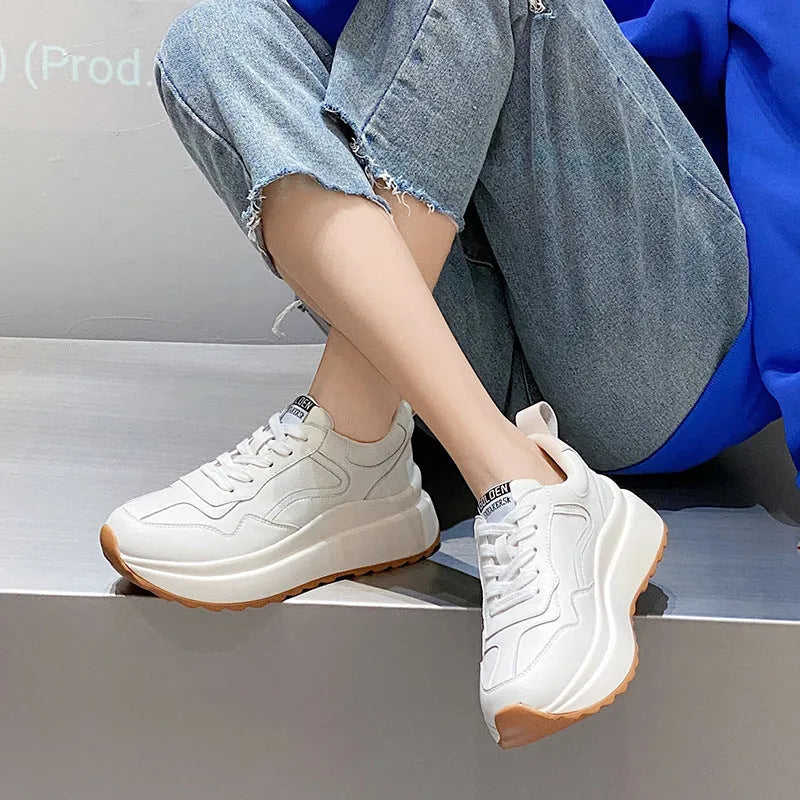 Women's beige cattlehide leather low-top casual sports shoes with cross strap and round toe.
