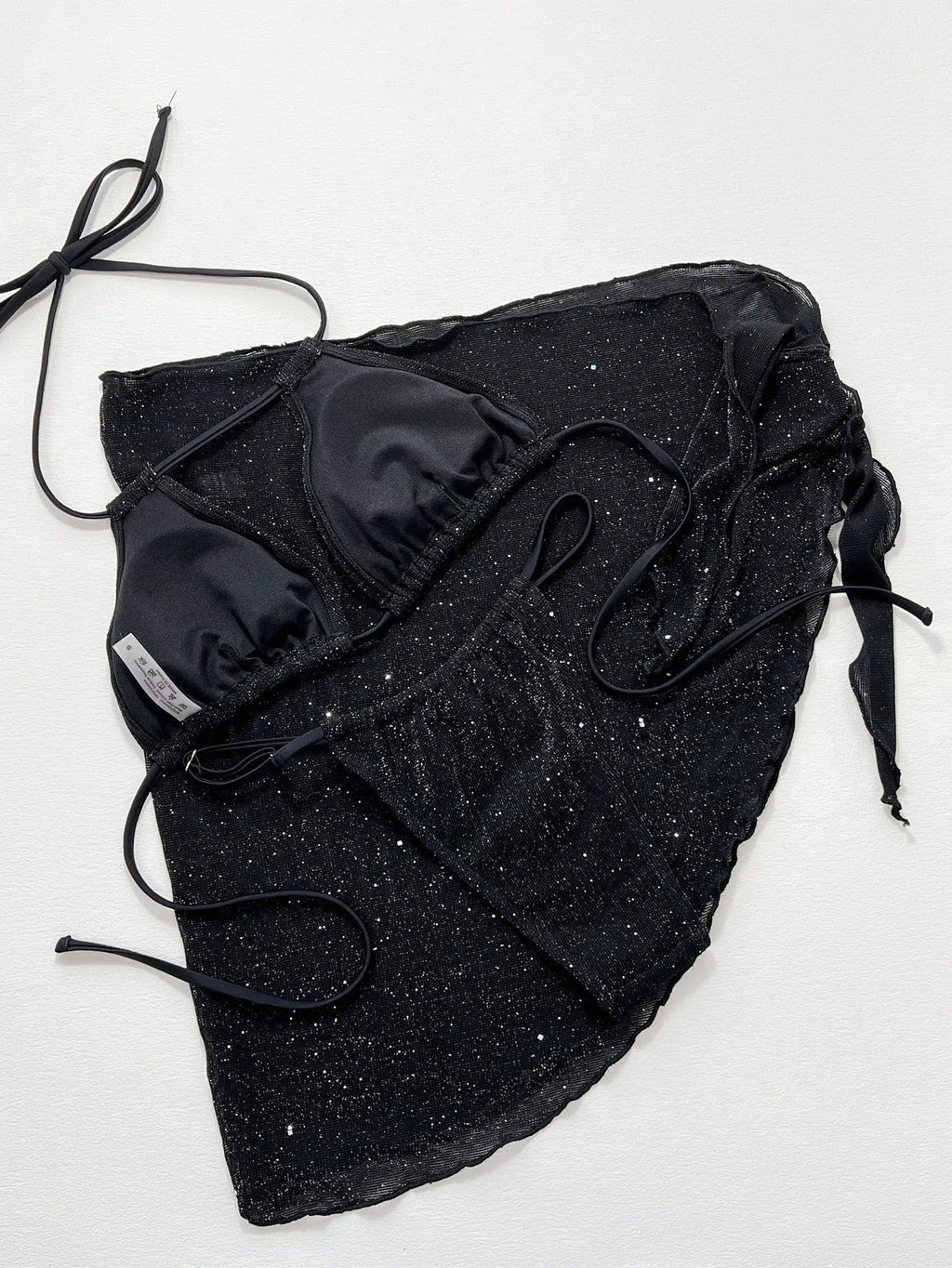Black three-piece bikini swimsuit set with polyester fabric, showing top and shorts components