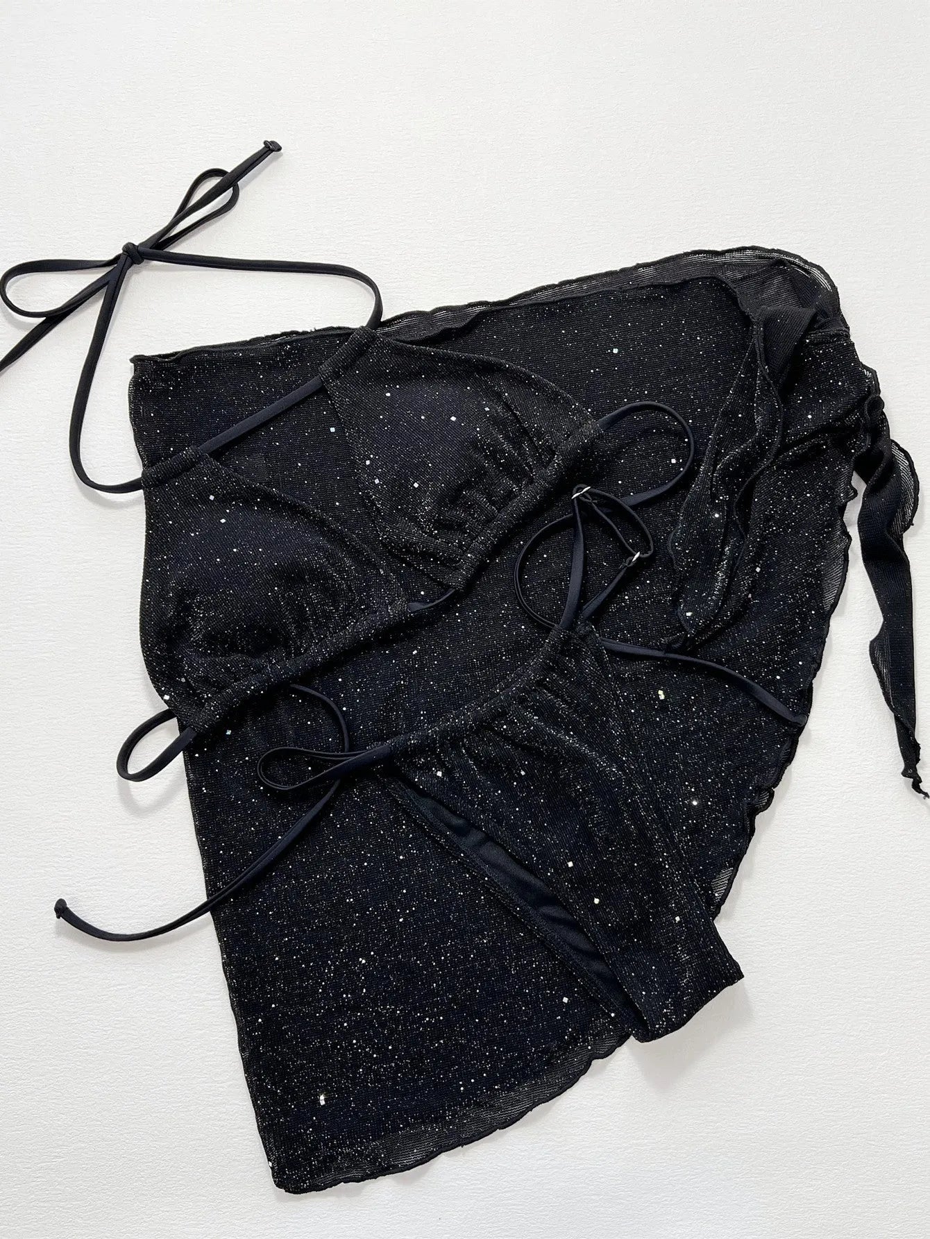 Black three-piece bikini swimsuit set with polyester fabric, showing top and shorts components