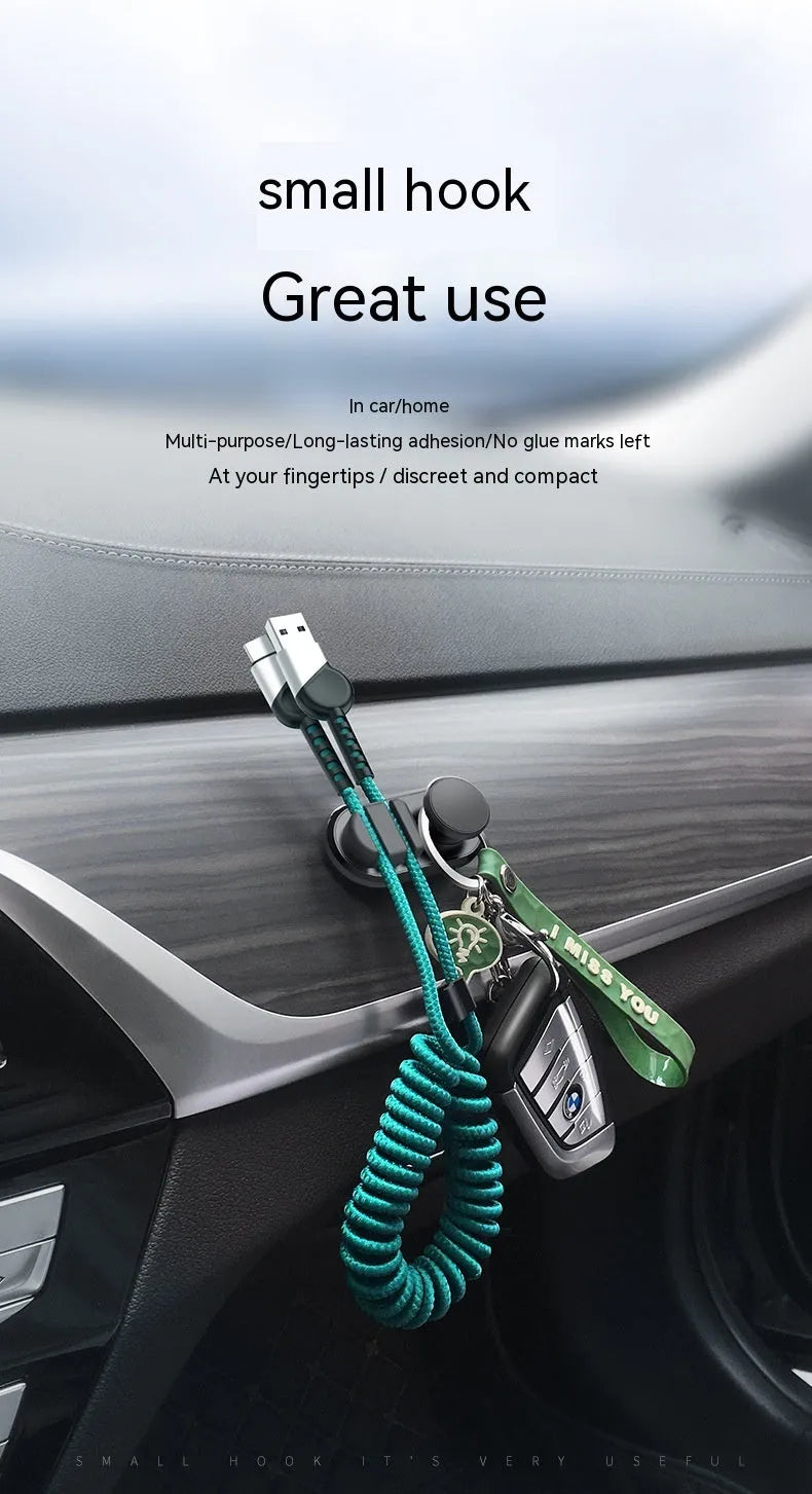 Compact dark green ABS silicone data cable storage hook for car or home use.