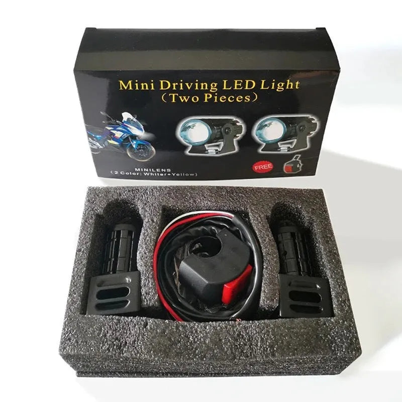 Motorcycle spotlight with dual-colour lens, aluminium housing, showing white and yellow light modes.