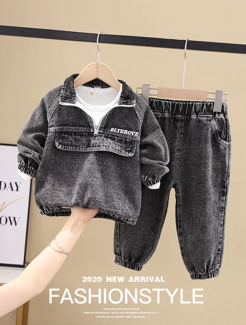 Boy wearing a black denim two-piece suit set with long sleeves, Korean style.
