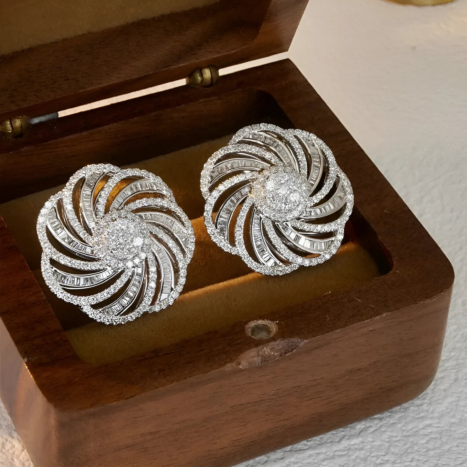 Copper geometric line flower design earrings with inlaid zircon in white gold colour on a neutral background