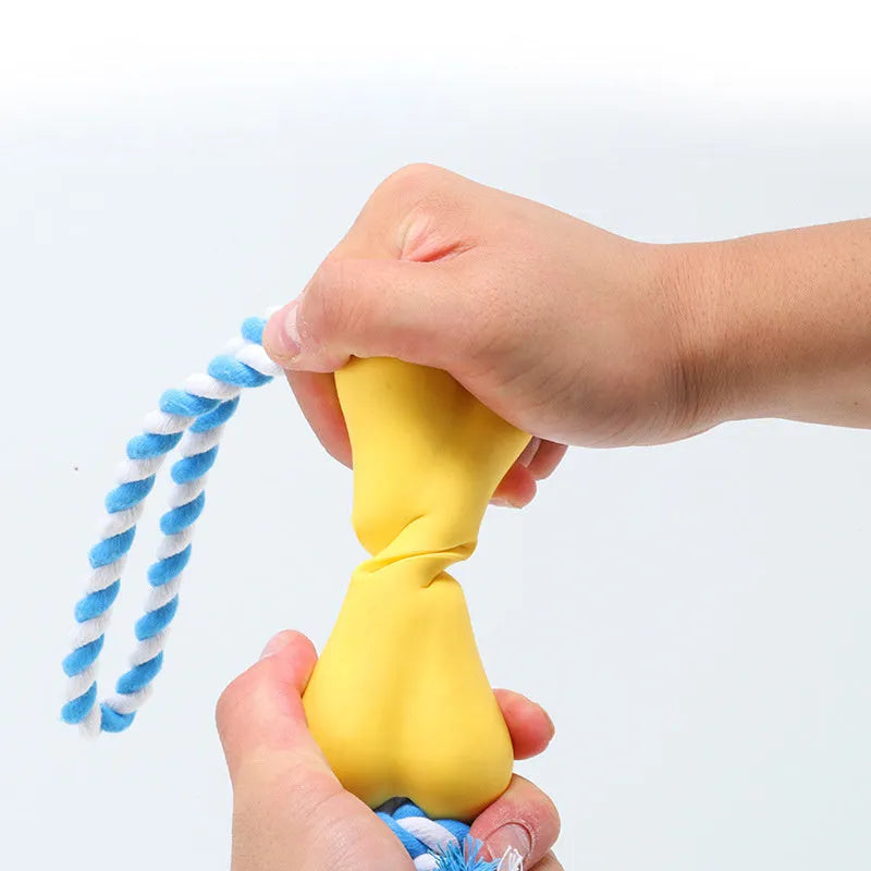Green porous leaking bone dog toy with rope knot construction for chewing and treat stuffing