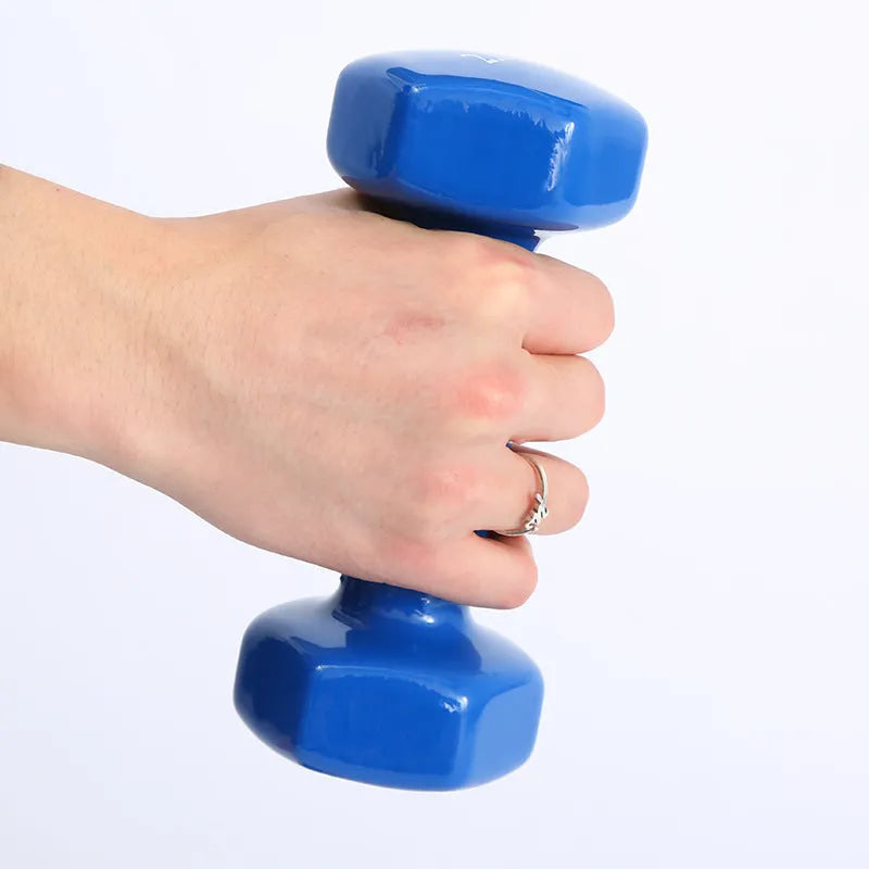 Brightly coloured plastic fitness dumbbells on a floor, showing glossy surface and multiple weight options.