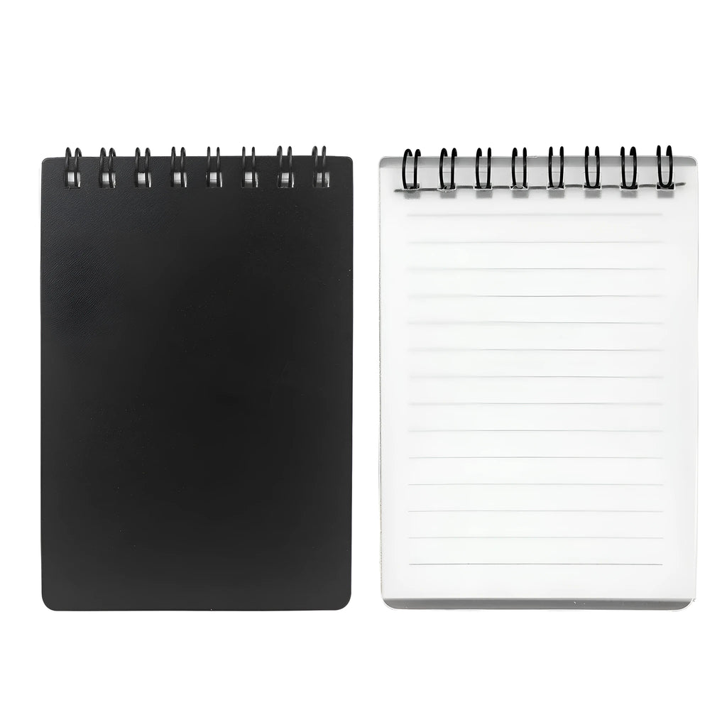 Spiral-bound black business notepad with pen and cleaning rag on a desk.